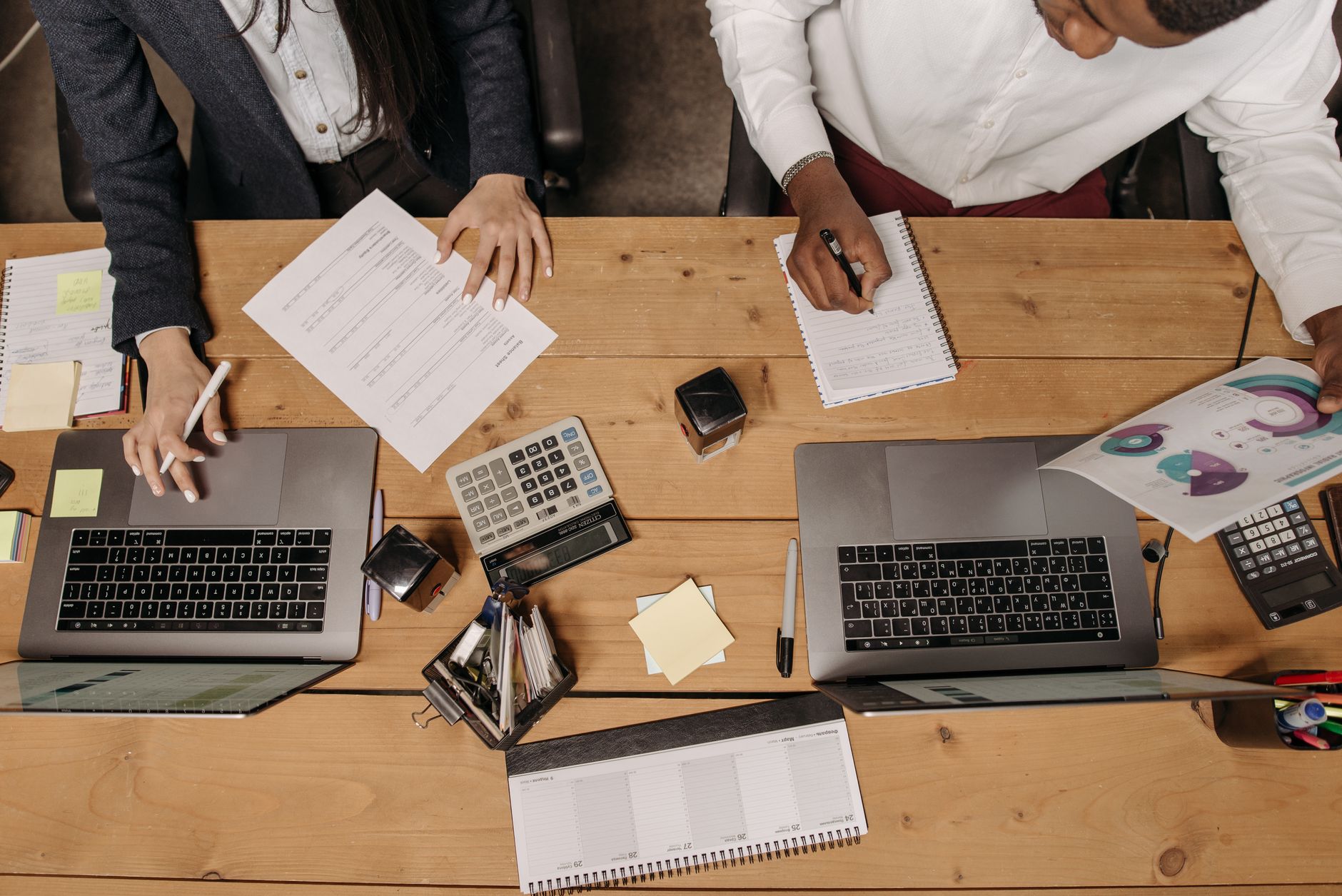 High-angle view of professionals working collaboratively with laptops and documents in an office. — High-Quality Bathroom Pan