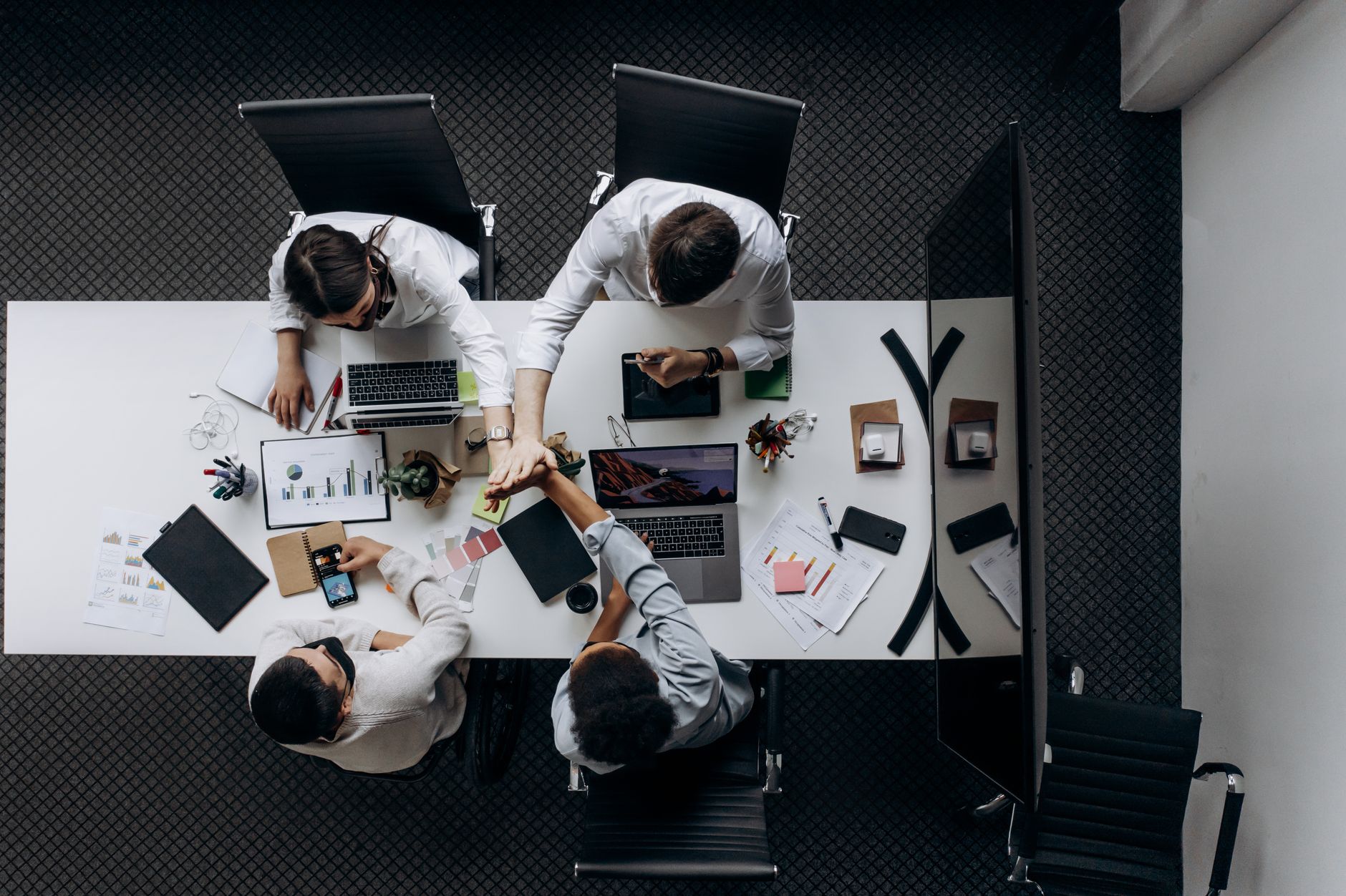 High angle view of colleagues collaborating around a conference table in a modern office setting. — How To Play Web Slots To