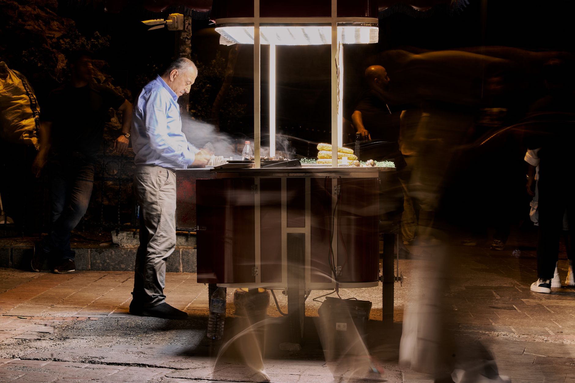 Street vendor cooking food at night with blurred people passing by. — Solving Common Issues Related to DLL Directories